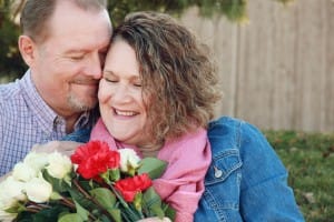 Married Couple Valentines Day Hug with Flower Stock Photo