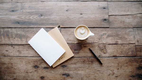 Coffee and Notebook on a Wooden Table Church Stock Photo