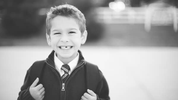Smiling Boy With Backpack Religious Stock Photo