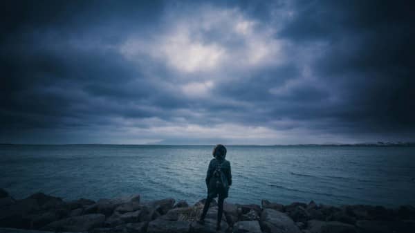 Youth out in Stormy Weather at the Beach Christian Stock Photo