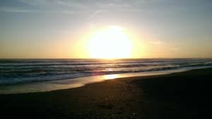 Setting Sun Over Beach Profile Ministry Stock Photo