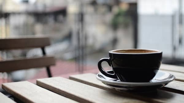 Cup of Coffee on a Table Christian Stock Image