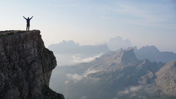 Man Worshiping From a Mountain Top Christian Stock Photo