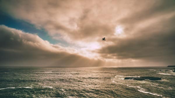 Ocean Sunset Obscured by Clouds Religious Stock Image